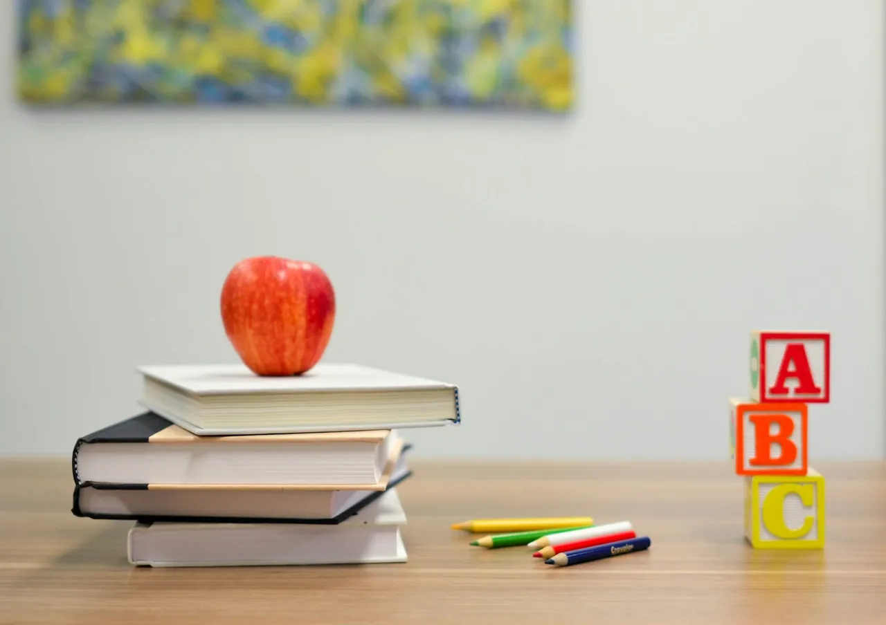 Apple and books on a school desk